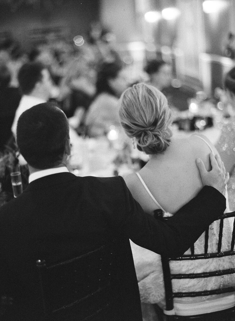 Couple embracing at their destination wedding reception, with all guest travel handled by their advisor