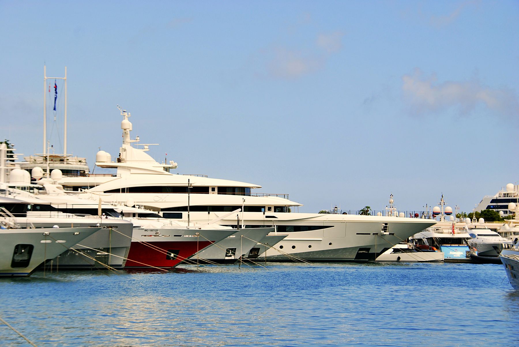 Luxury yachts docked in the marina of Monaco on a sunny Mediterranean day