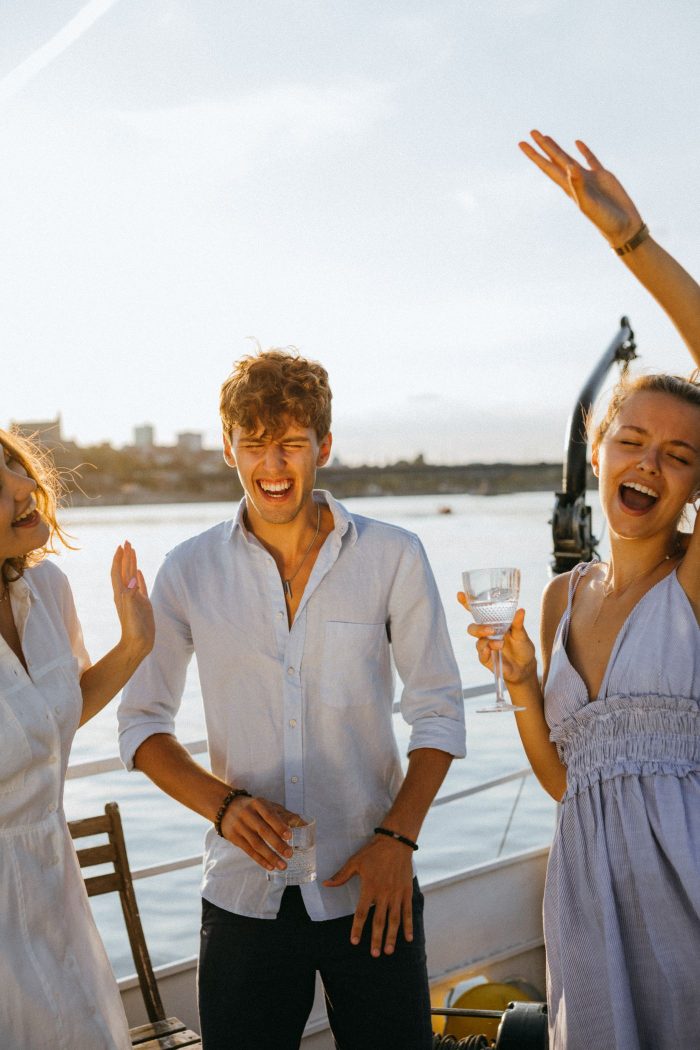Group of friends celebrating a birthday trip on a yacht